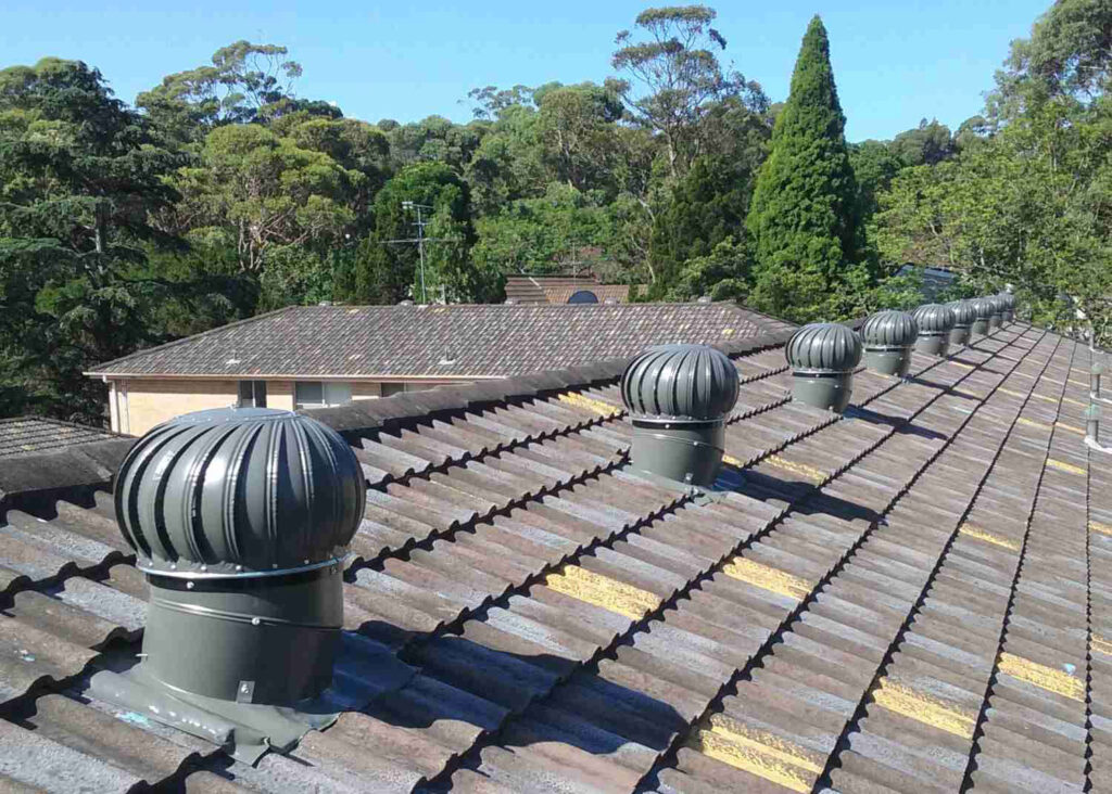 Twista whirlybirds product multiple installation grey on concrete tile apartment block roof